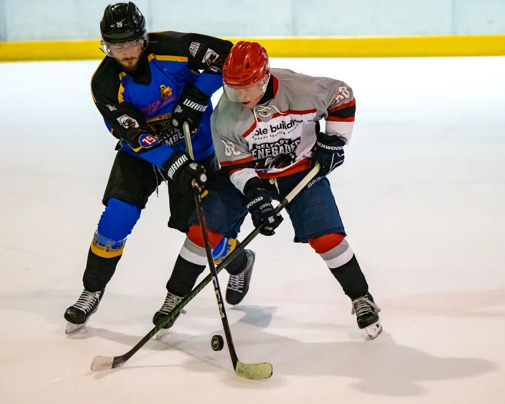 Bombers and Renegades players battle for the puck
