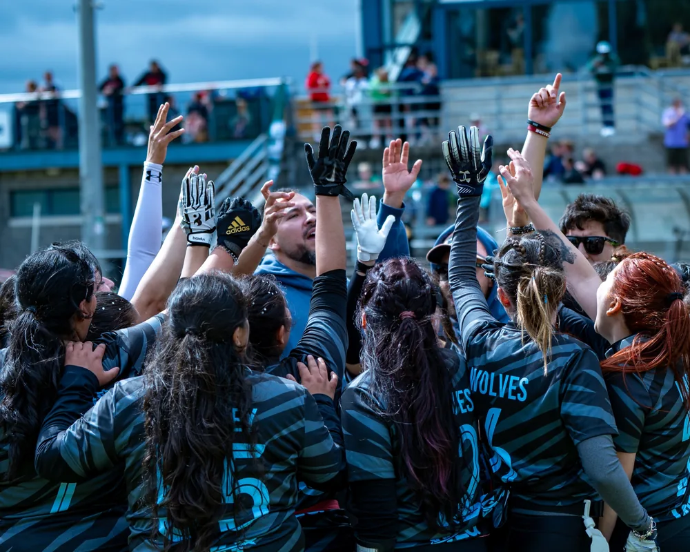 Dublin City Wolves raise their hands in a huddle after winning the Fianna Bowl.