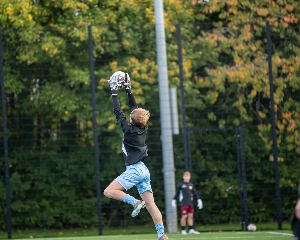 Player controls an airborne ball. H&W Welders Reserves v Warrenpoint Reserves.