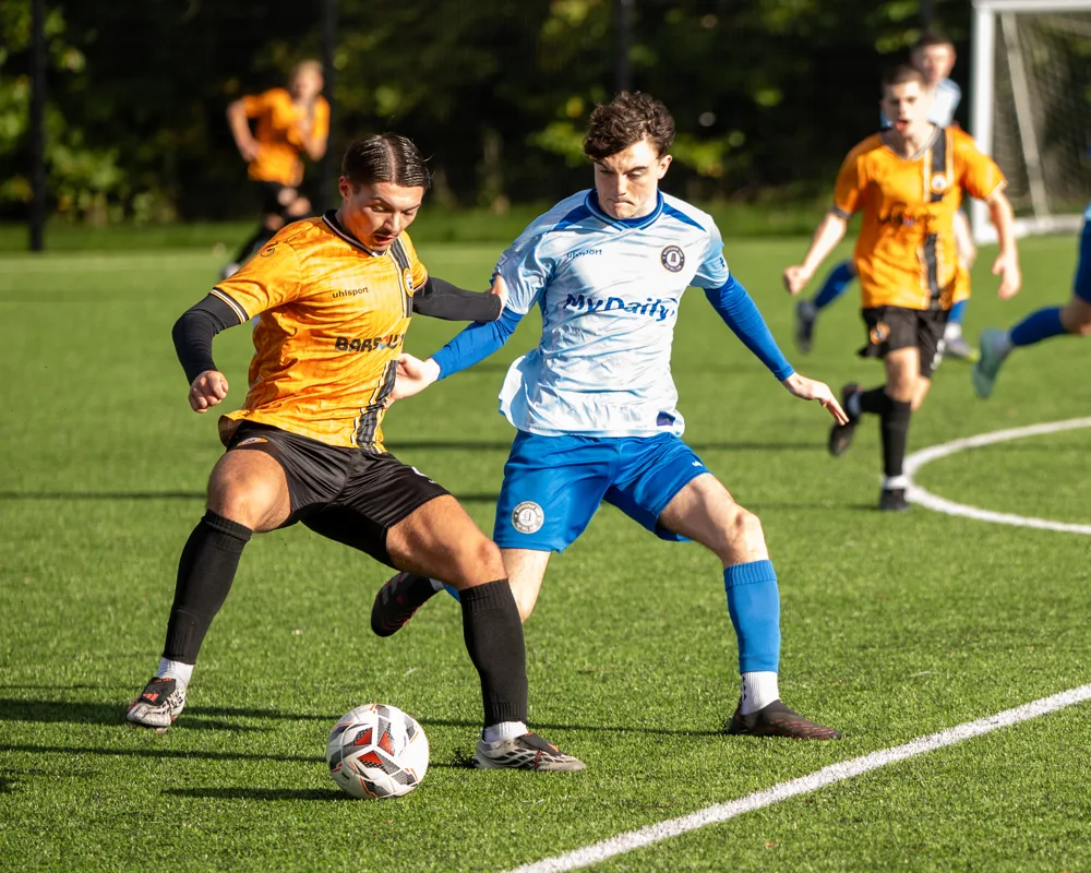 Opponents contest possession. H&W Welders Reserves v Warrenpoint Reserves.