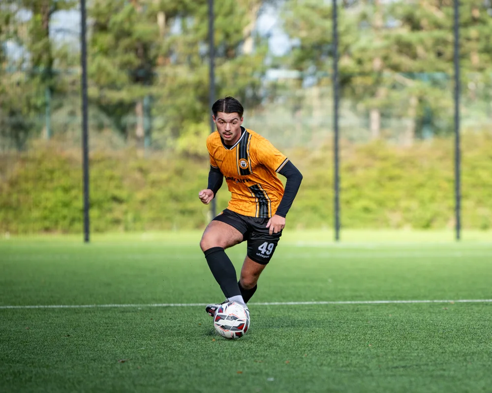 Player prepares to pass. H&W Welders Reserves v Warrenpoint Reserves.
