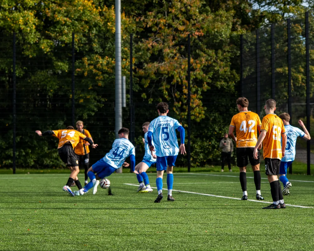 Players contest play in the penalty area. H&W Welders Reserves v Warrenpoint Reserves.