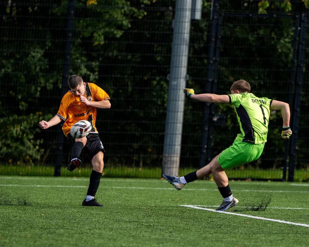 Player challenges the goalkeeper. H&W Welders Reserves v Warrenpoint Reserves.