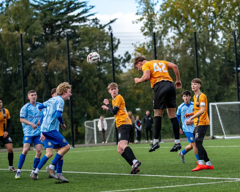 Player jumps for a header. H&W Welders Reserves v Warrenpoint Reserves.