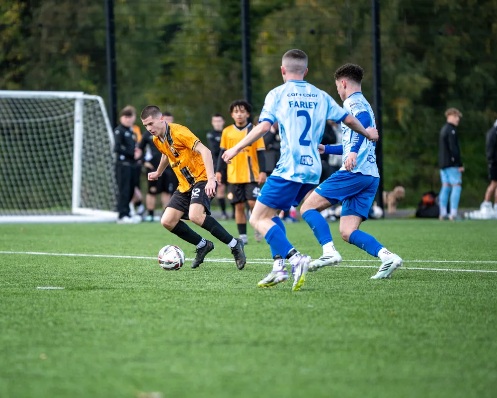 Players contest the ball near goal. H&W Welders Reserves v Warrenpoint Reserves.