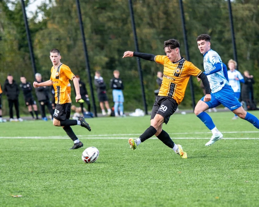 Player strikes the ball. H&W Welders Reserves v Warrenpoint Reserves.