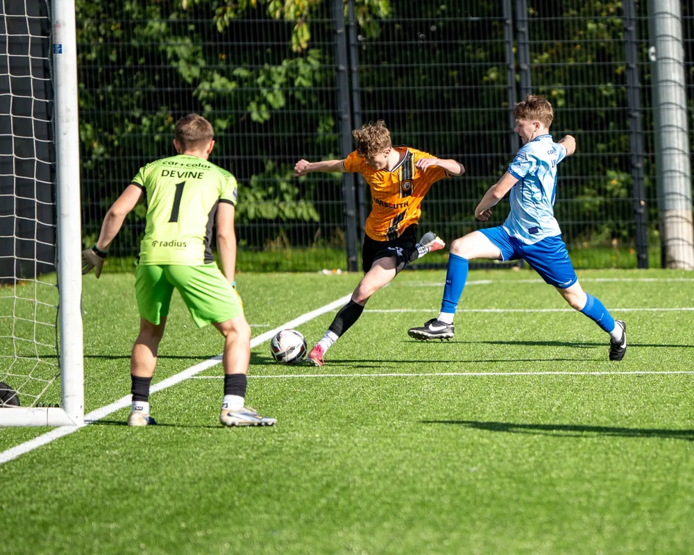 Players challenge near the goalkeeper. H&W Welders Reserves v Warrenpoint Reserves.