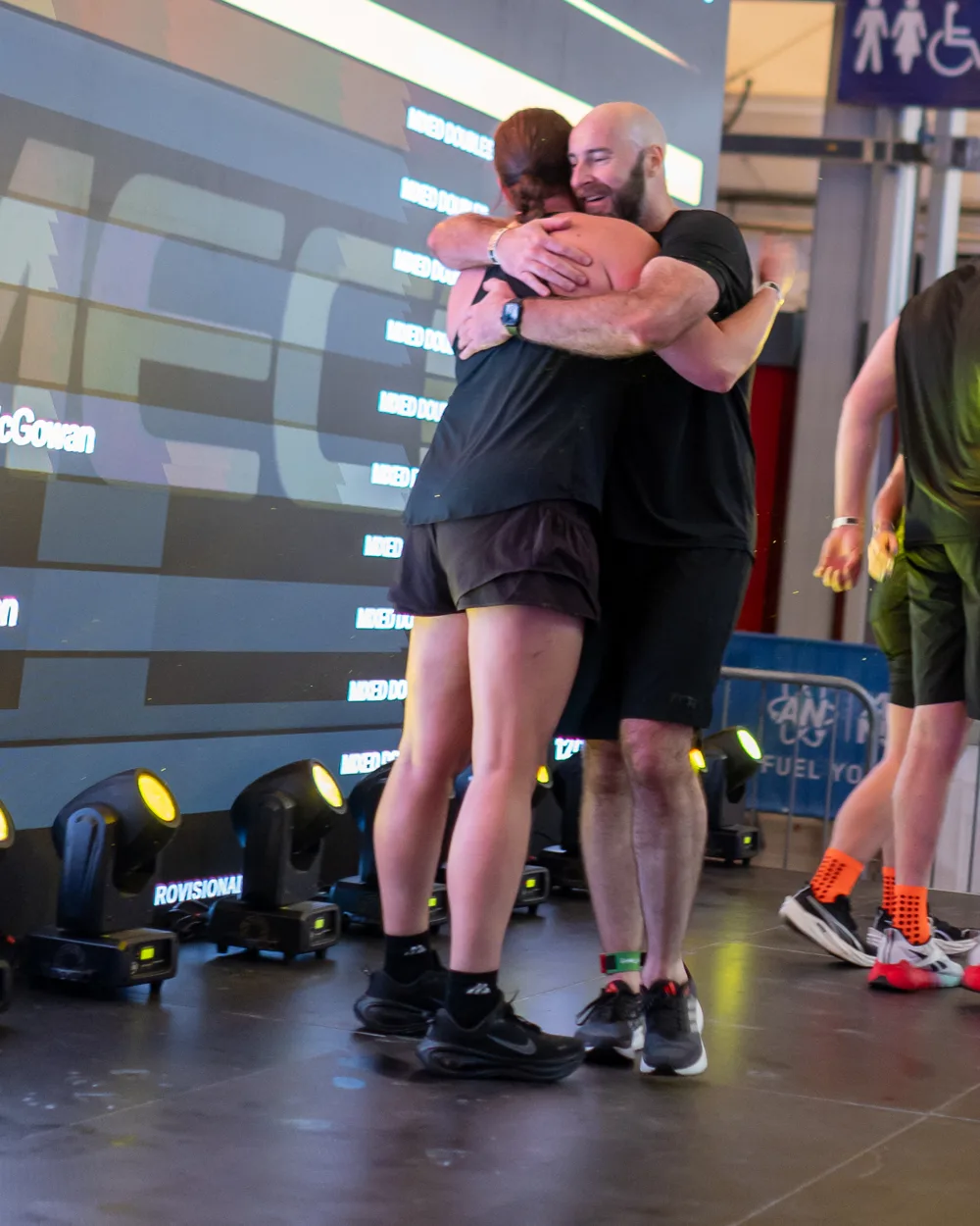 Competitors embrace beside the display. Mecca Sim 5.