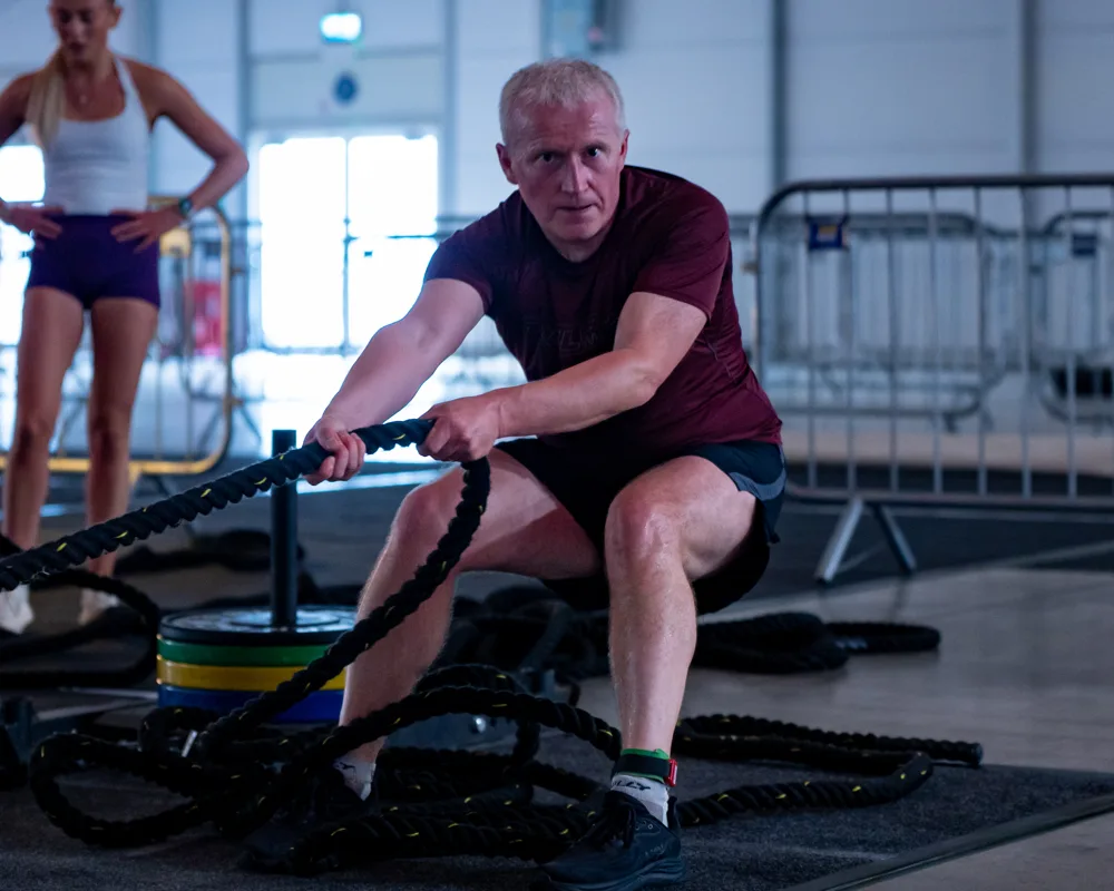 Athlete pulls on a rowing machine. Mecca Sim 5.