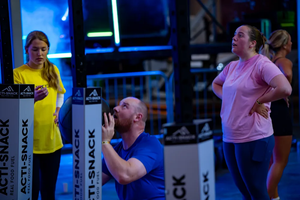 Athletes pause at an exercise station. Mecca Sim 5.