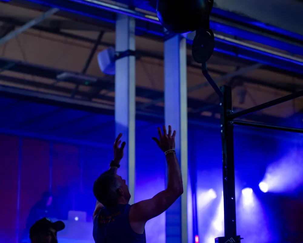 Athlete reaches overhead with a ball. Mecca Sim 5.