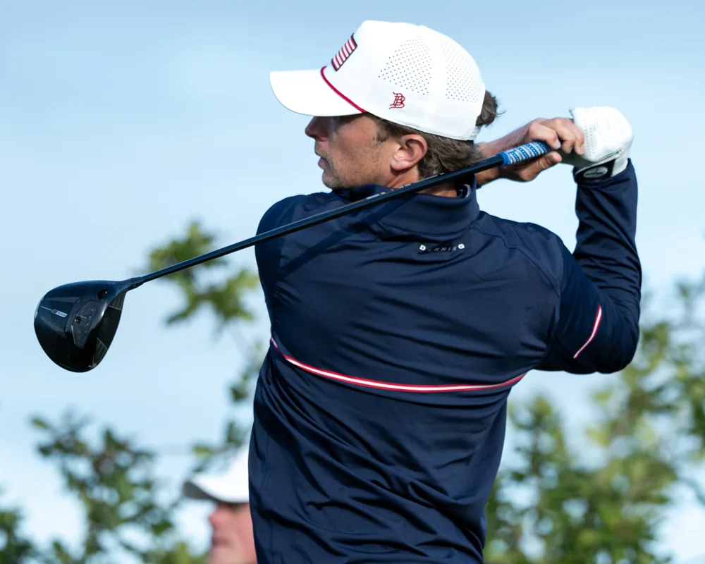 A Team USA golfer follows through with a driver.