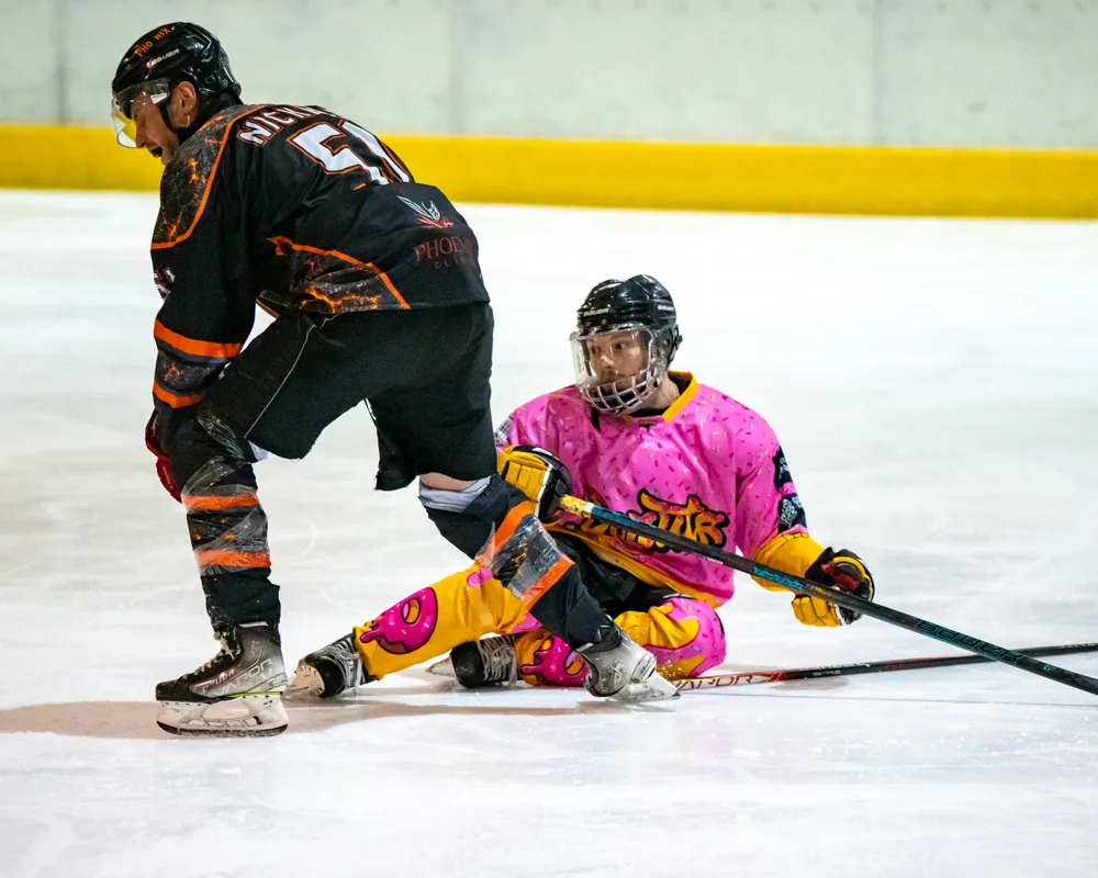 Donuts player on the ice with a Phoenix player in the foreground