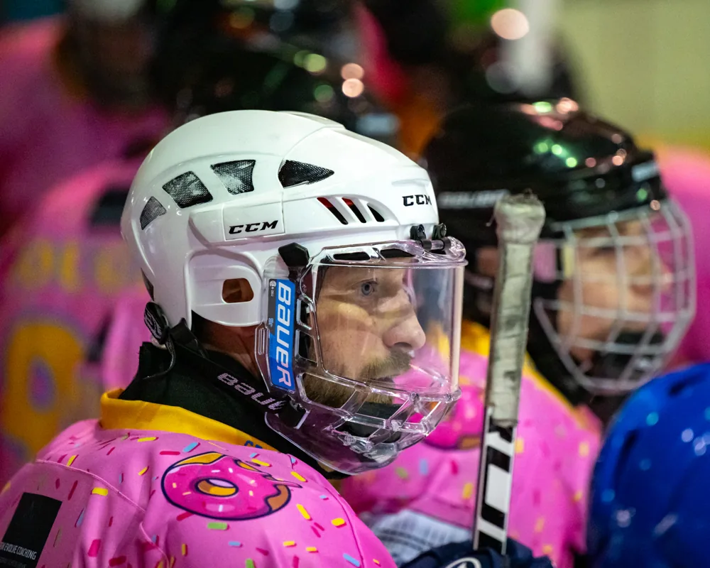 Donuts player in a white helmet on the bench