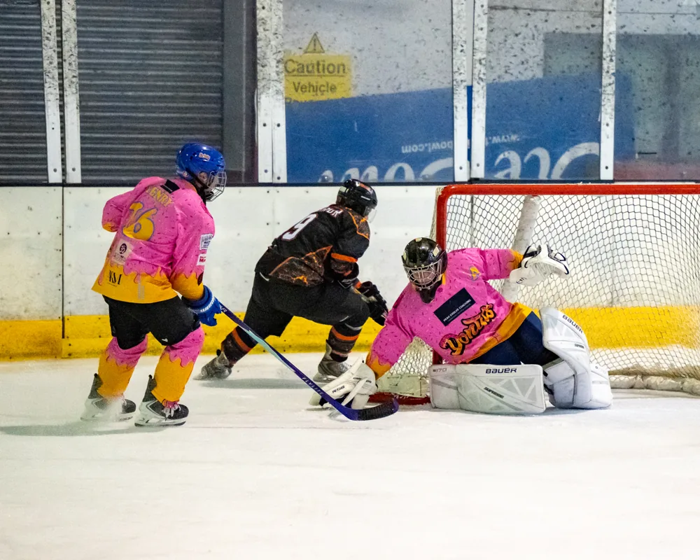 Phoenix forward attacks the Donuts goal