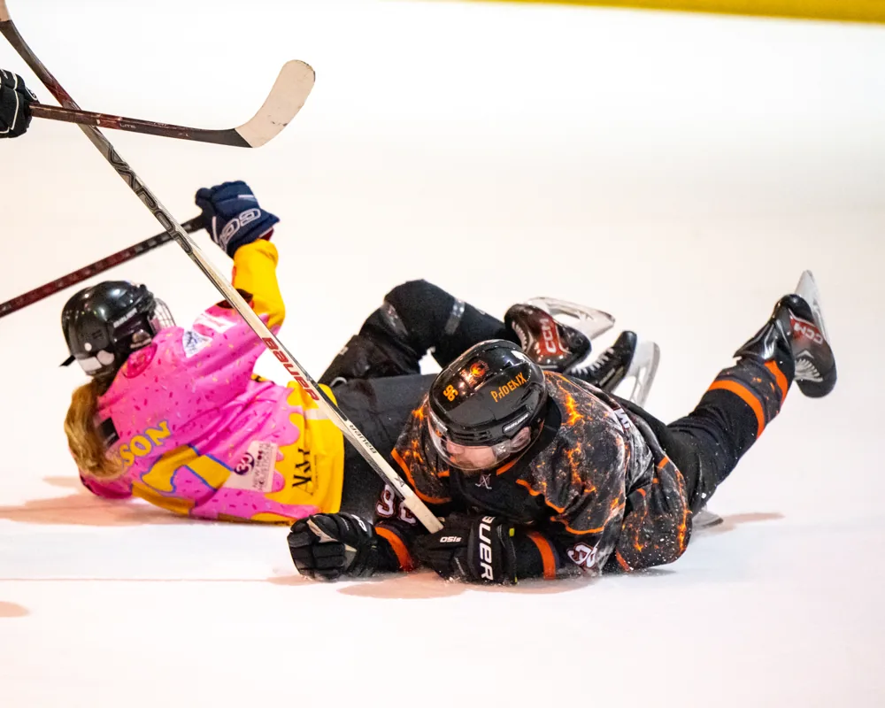 Phoenix and Donuts players tumble onto the ice