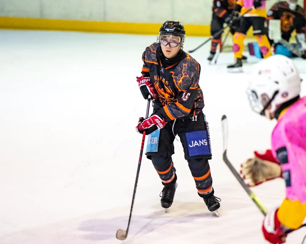Phoenix player with a pink stick faces an opponent