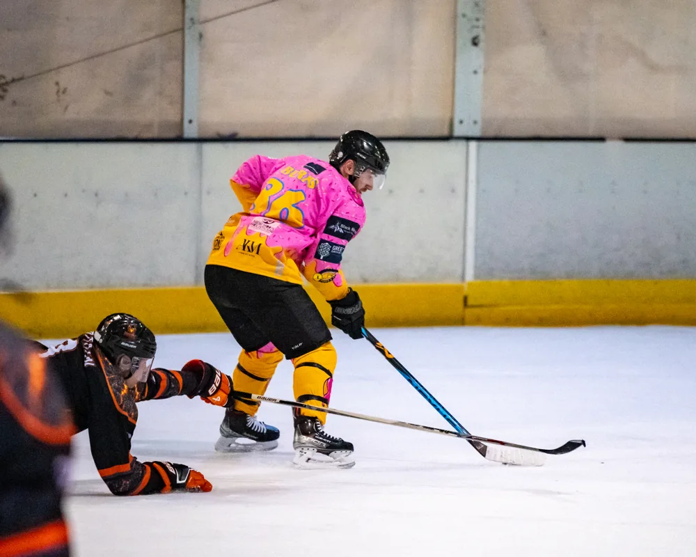 Donuts player with a fallen Phoenix player in the foreground