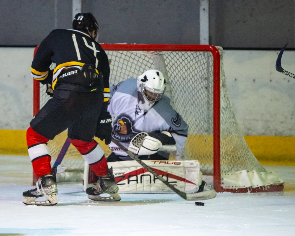 Players gather near the goalkeeper. Belfast Phoenix v Wild Hawks.
